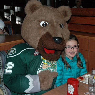 Everett Silvertips mascot Lincoln gets comfortable next to Arlington fan Becki Toop during the team’s ‘Tip a Tip’ night on Feb. 22.
