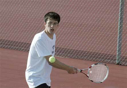 Arlington singles player No. 3 Marty Thordarson backhands a return from Marysville's C.J. Nearman on his way to a 6-1