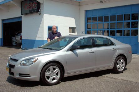 Dwayne Lane general manager Brian Frauenholtz shows the 2009 Chevy Malibu