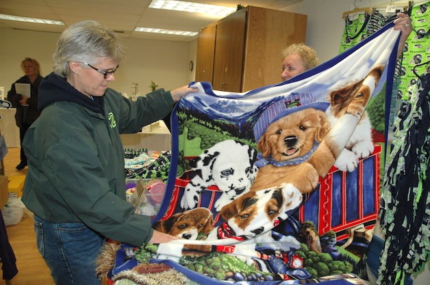 Helga Halverson of Marysville has a quilt looked at by Sheryl Tucker of Stanwood Nov. 14.