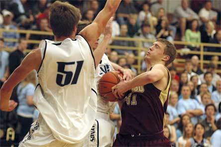 Jacob VonPein gets caught up between two defenders while attempting a shot in the key.