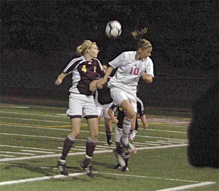 Lakewood senior Erin Dierickx does battle with prolific King’s forward Hillary Zevenbergen.