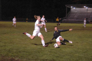 Freshman midfielder Lauren Dusold tries to clear the ball past the sliding Lake Stevens defender.