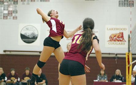 Sophomore middle hitter Brittany Parmentier attacks from a back position on the front line.