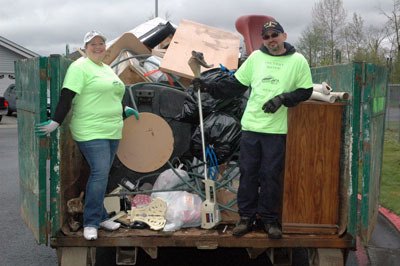 Country Manor President D'Ann Gidos and Vice President Robert Hernandez show off their full dumpster