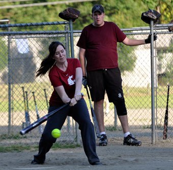 Sticks n’ Chicks’ Bree Doyals chases a pitch as teammate Matt Rolf looks on during a coed softball game against Cascade Valley Wednesday
