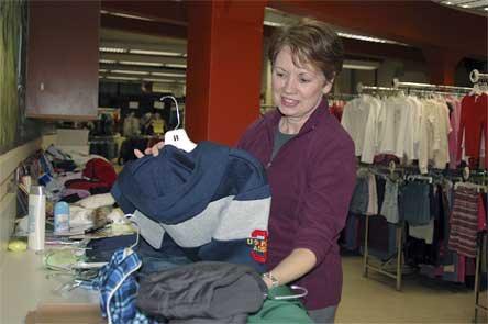 Kids’ Kloset Co-Director Linda Dussault sorts through some of the organization’s recent donations on Tuesday