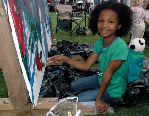 Jewel Brown is all smiles as she contributes to the collaborative canvas at the ‘Art in the Park’ on Sept. 14.