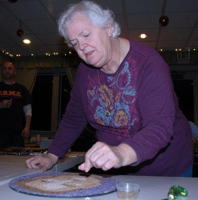 Elliot Carbajal’s mother Louise sprinkles in some seeds for the eyebrows of her son’s face that will appear in the ‘flora-graph’ on the Donate Life America float during the Jan. 1 Rose Parade.