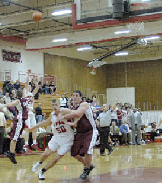 Senior post Spencer Elwell gets ready to rebound as teammate Nick Soriano nails one of his seven three-pointers against Cascade.