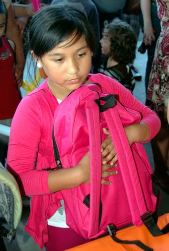 Michele Estrada tightly clings to her new pink backpack at the Aug. 28 ‘Back2School Rally’ at Presidents Elementary.