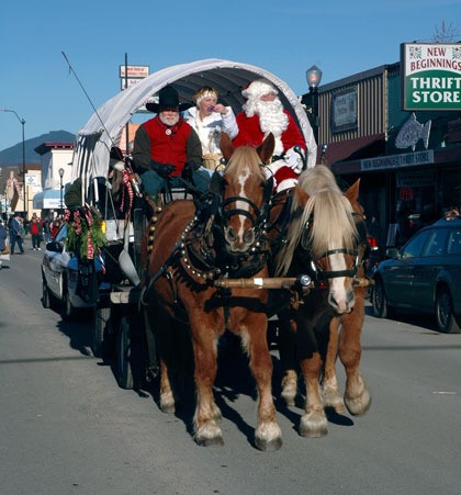 Santa Claus catches a ride on a Gala Carriage covered wagon to wave to kids of all ages at the Hometown Holiday parade in Arlington on Dec. 4.