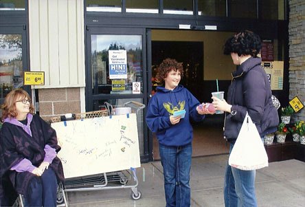 Haller Middle School student Kai Gallo accepts a donation for Kids’ Kloset from a community member earlier this month.