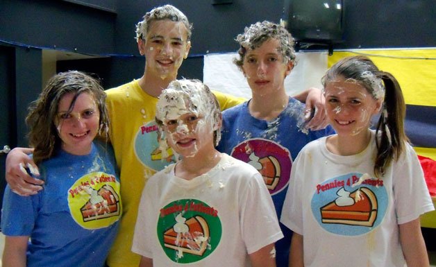 Post Middle School eighth-grade ASB officers manage to grin through whipped cream faces. Front row from left