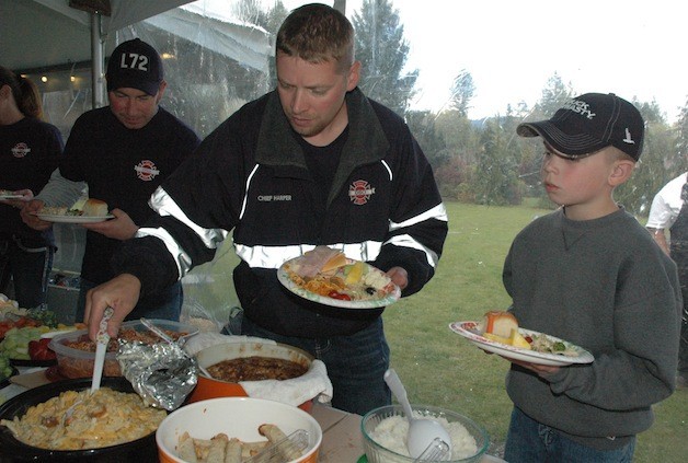 As Oso firefighter Rob Fisher makes his way up the food line