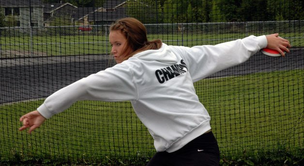 Junior Alexis Sarver slings the discus during practice at Arlington High School.
