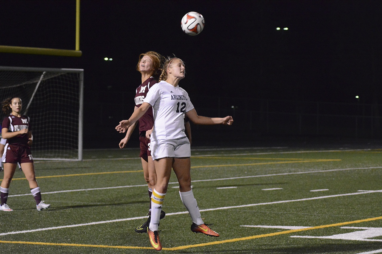 Brandon Adam/Staff Photo                                Arlington’s McKenzie Buell heads the ball.