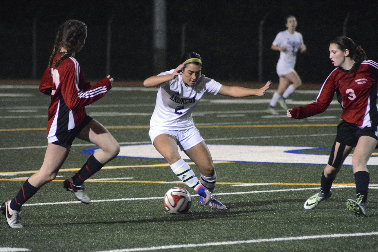 Brandon Adam/Staff Photo                                Arlington’s Hailee Wrzesinski controls the ball between two Snohomish defenders.