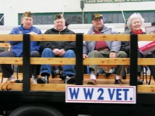 Arlingtons surviving World War II veterans greet the cheering crowds during the citys