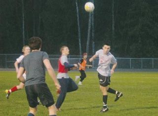 Senior Richard Gonzalez attempts to gain control of the soccer ball with a head bounce.