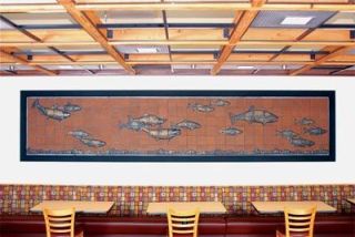 Marguerite Goff recently completed a wall mural of fish swimming upstream for the TOP Foods store in Snohomish and received a request for a second