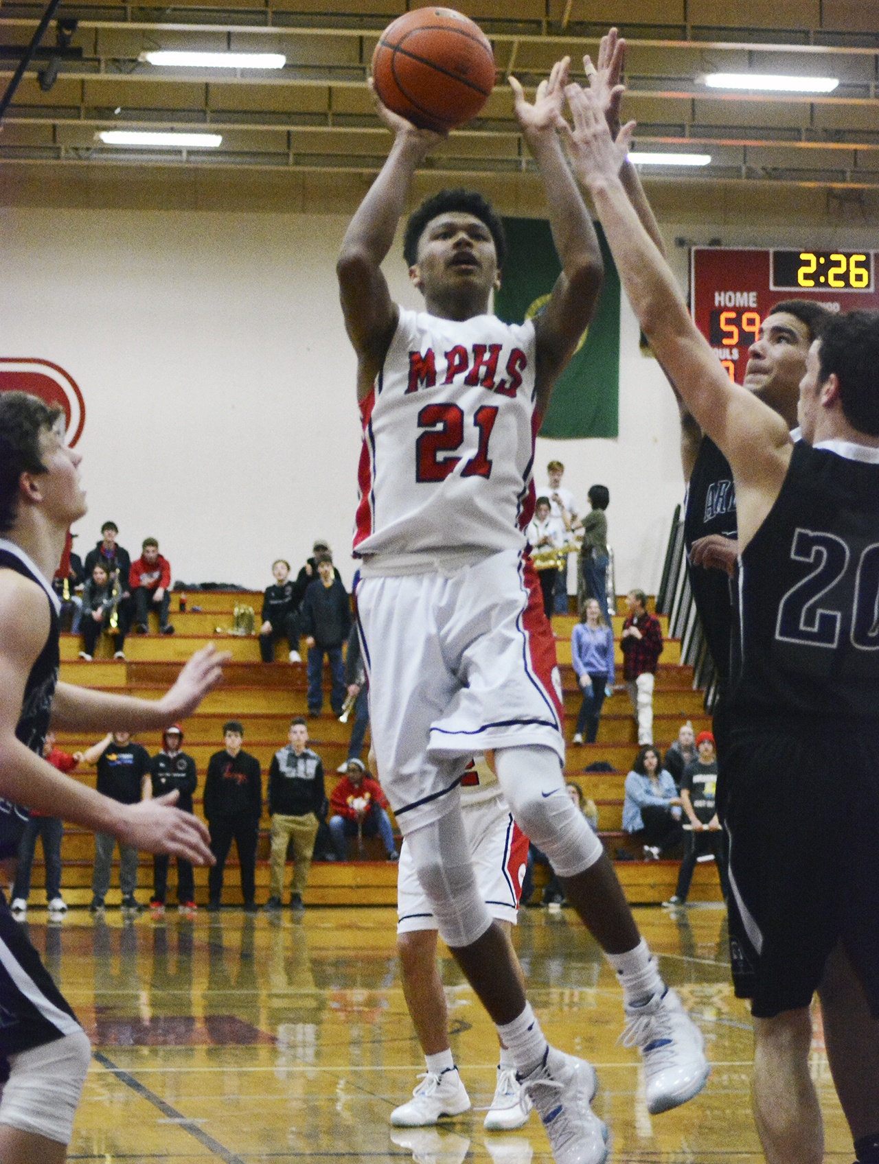 Raequan Battle of Marysville-Pilchuck leaps above Arlington defenders. Brandon Adam/Staff Photo