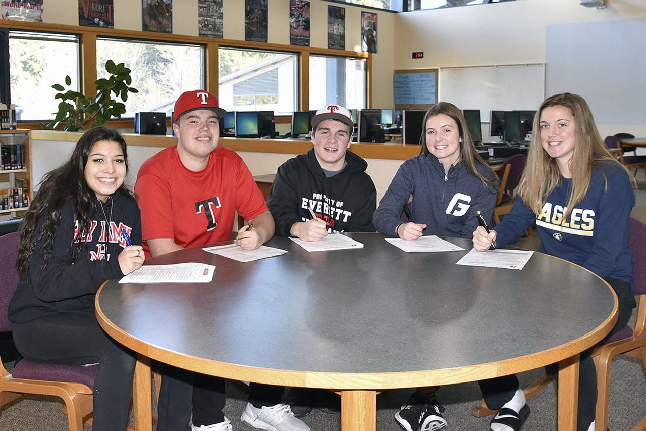 From left to right: Arlington seniors Kirsten Phillips, A.J. Croom, Tristan Sheward, Abby Anderson and Tahlia Miears signed their letters of intent Feb. 1. Courtesy Image