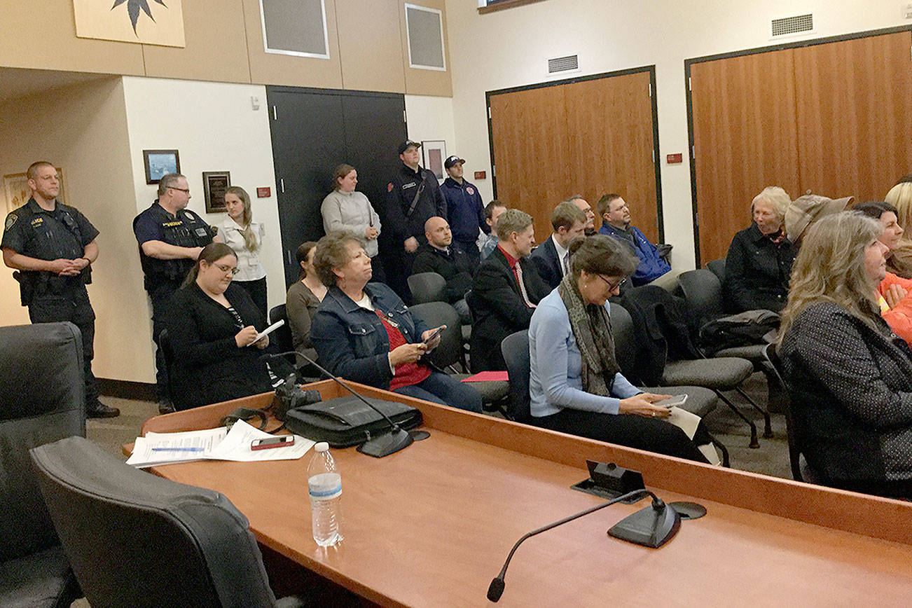 A crowd in the City Council Chambers shows its disappointment after finding out Arlington-Darrington did not place in the top three in the America’s Best Communities competition, missing out on millions of dollars that would have helped the area rebuild after the deadly Oso landslide. (Douglas Buell/Staff Photo)