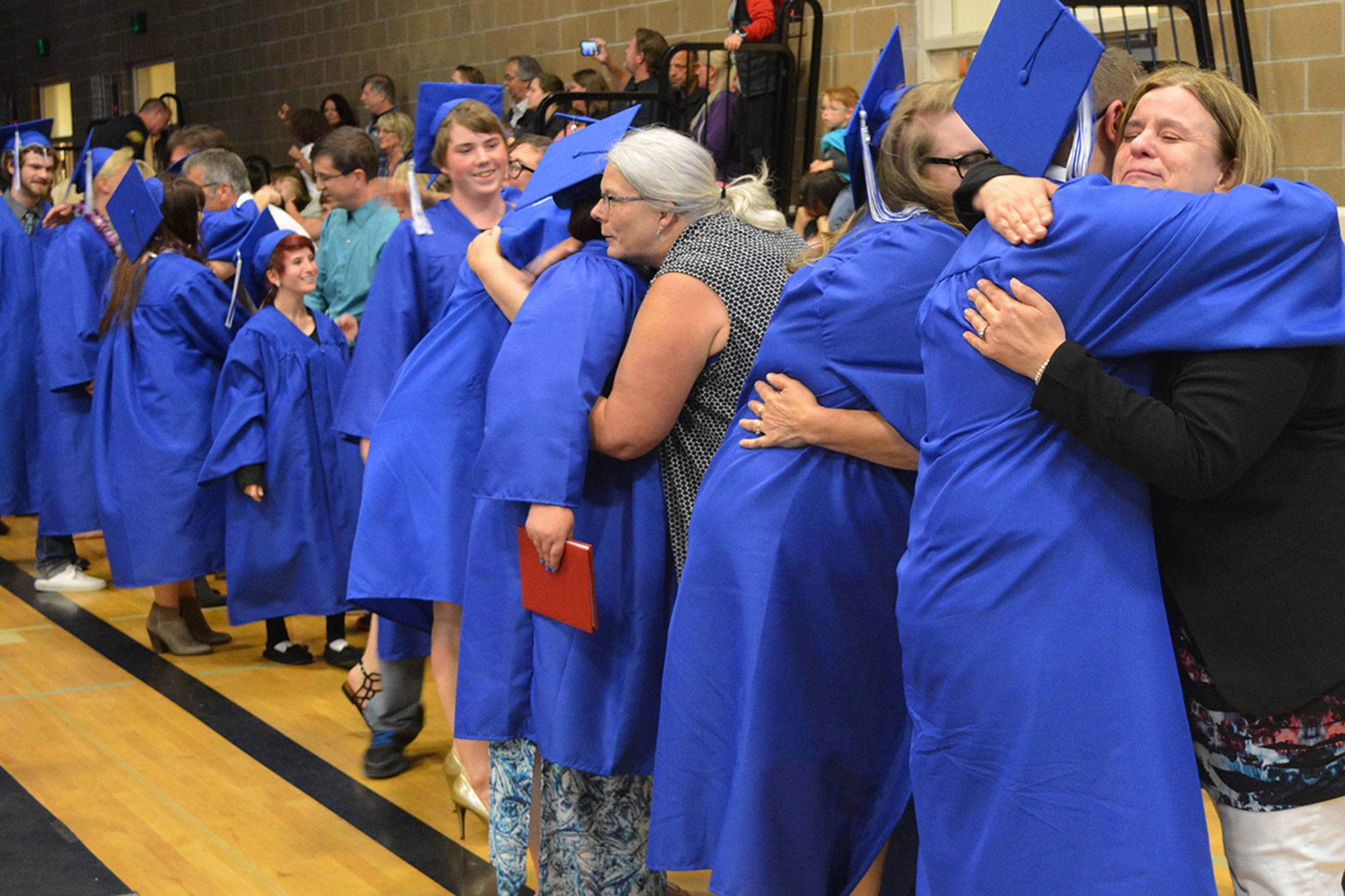 Graduation hugs show close bonds of Mountain View teachers, students