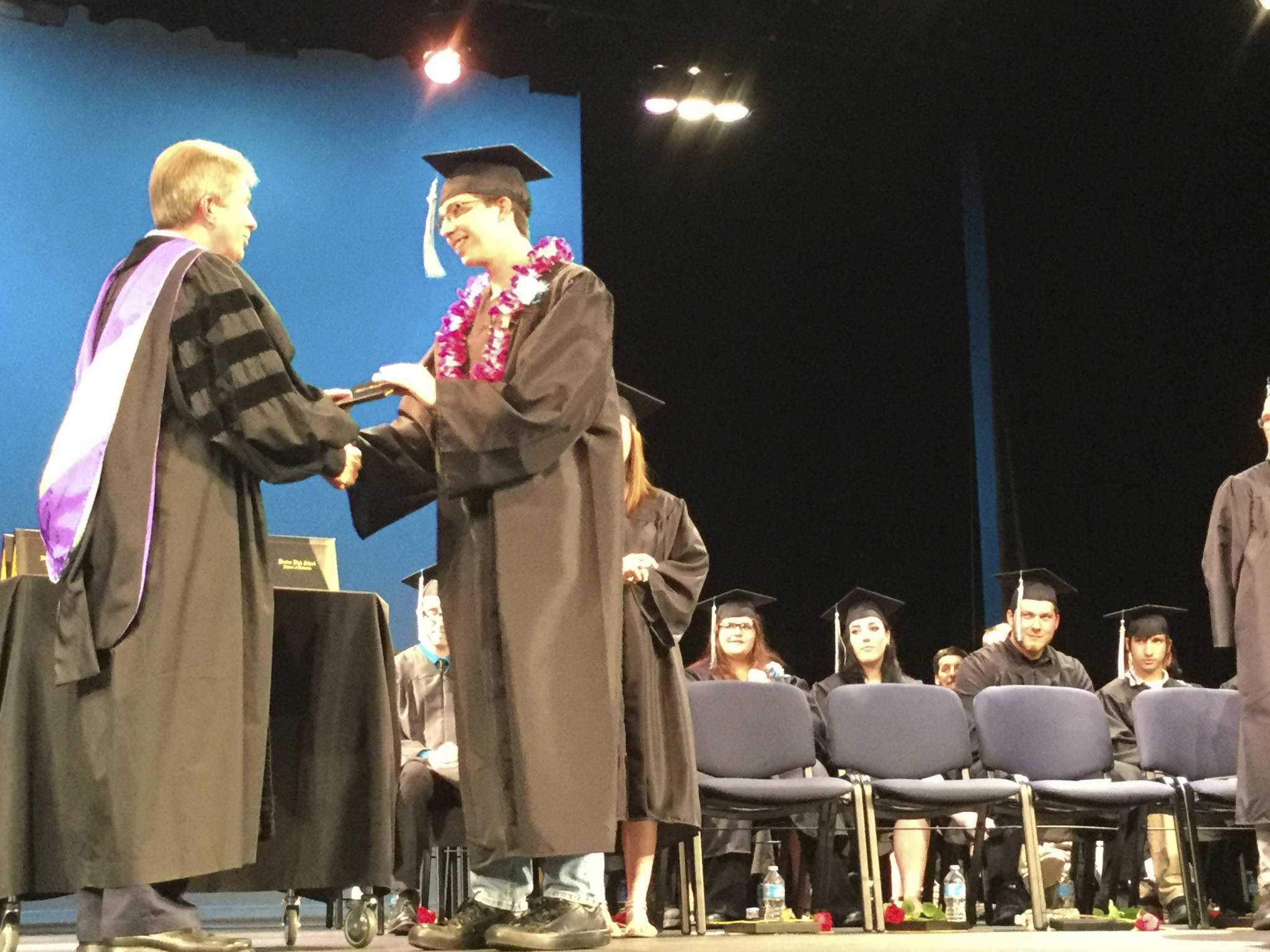 Arlington School Board President Jeff Huleatt presents Weston High School graduate Michael Griffith with his diploma during the Class of 2017’s commencement ceremony Wednesday in the Byrnes Performing Arts Center.