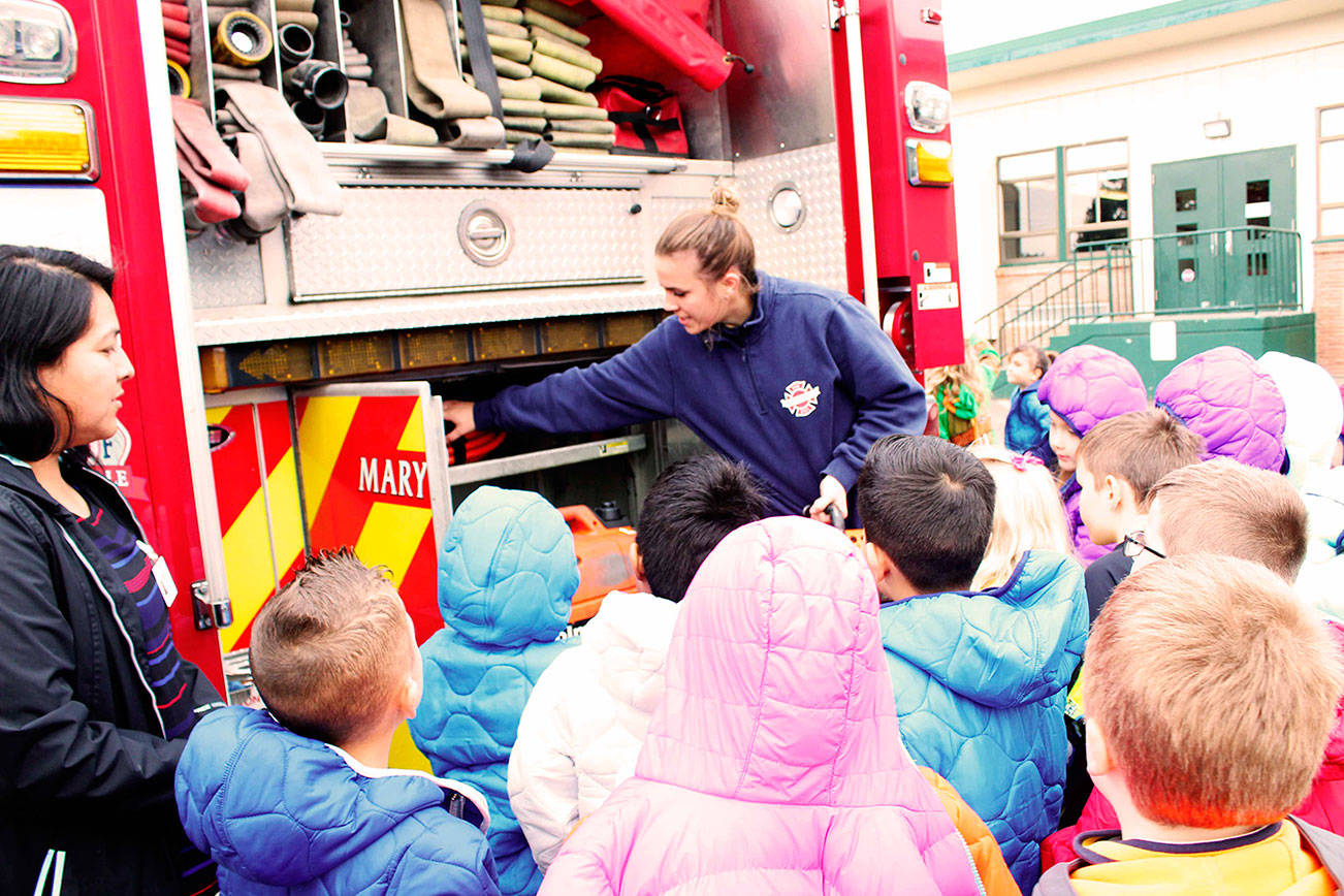 Kids get coats from firefighters
