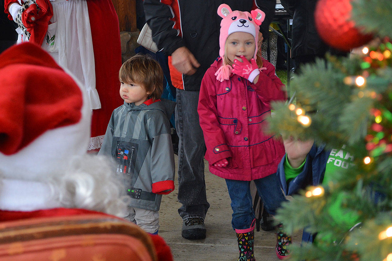 Umbrella in hand, Santa arrives in Arlington (slide show)