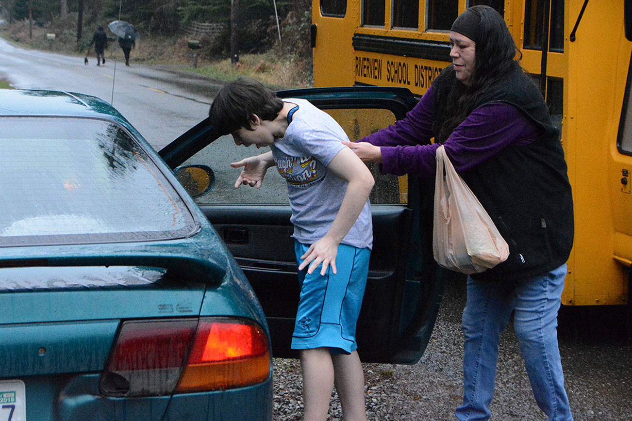 Steve Powell/Staff Photo                                 Terrie Decker helps her daughter Tawna into their car after being dropped off by the school bus. Decker wants Tawna’s previous driver back because he knew how to deal with her special needs.
