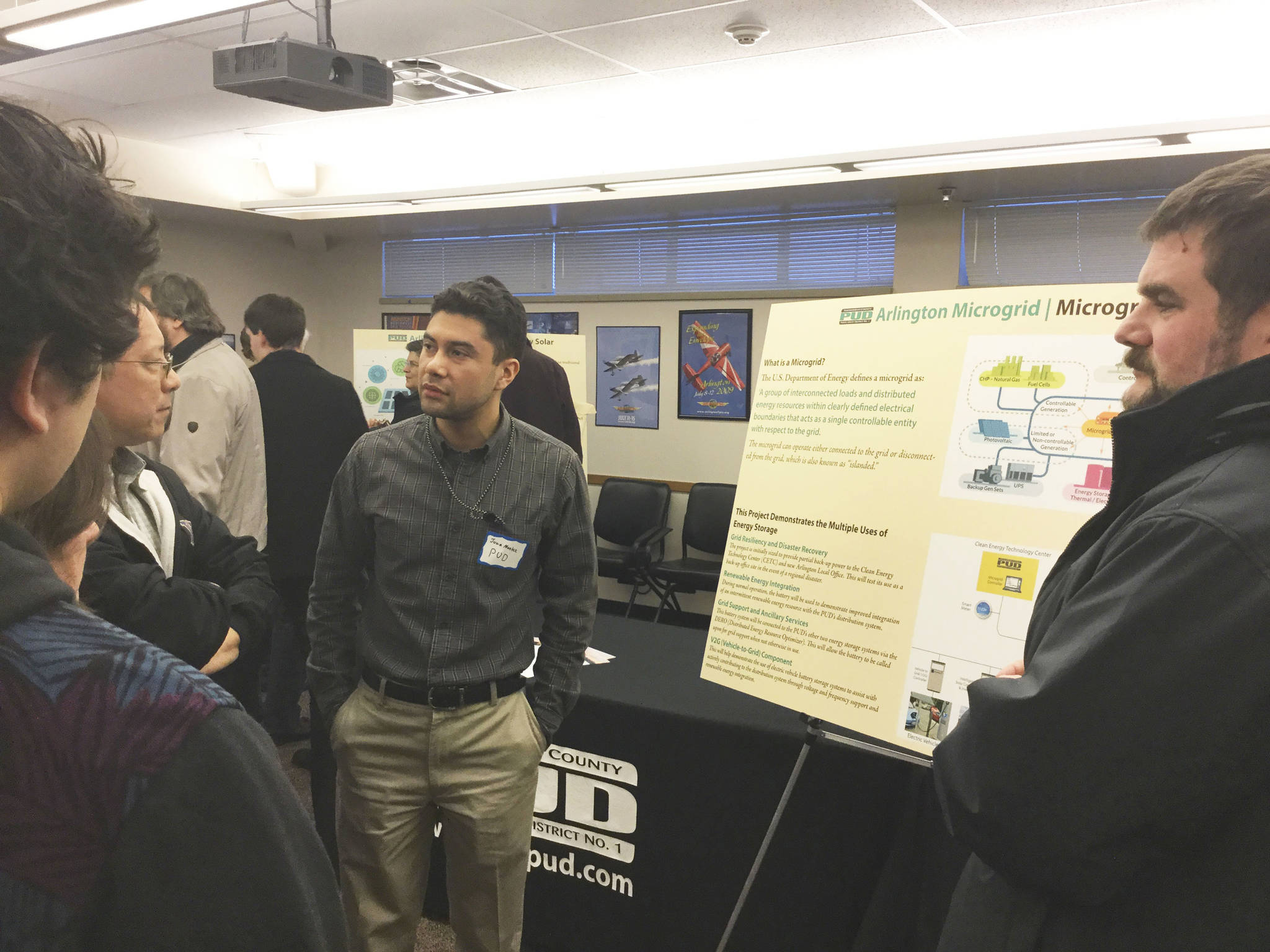 Snohomish County PUD engineer Juan Montez shares details about the utility’s planned Arlington Microgrid and Clean Energy Technology Center at an open house Wednesday at the Arlington Airport Office nearby. The center will feature a solar power array, vehicle electric charging stations, an education center and more.