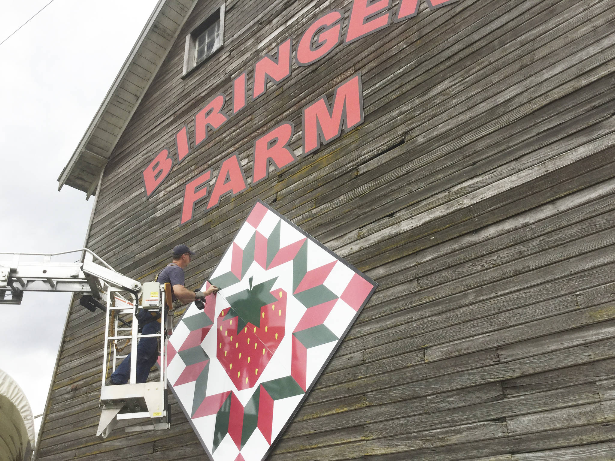 Scott Hines of Marshall Signs installs sections of a metal barn quilt at Biringer Farm on June 8 to kick off the new Stillaguamish Valley Barn Quilt Trail.
