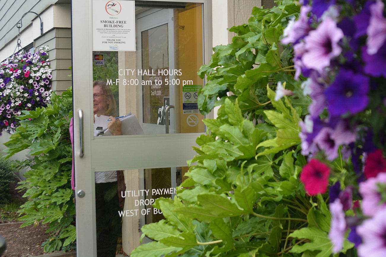 Steve Powell/Staff Photo                                Finance director Sandy Langdon walks out of City Hall after the vote for a new Civic Campus.