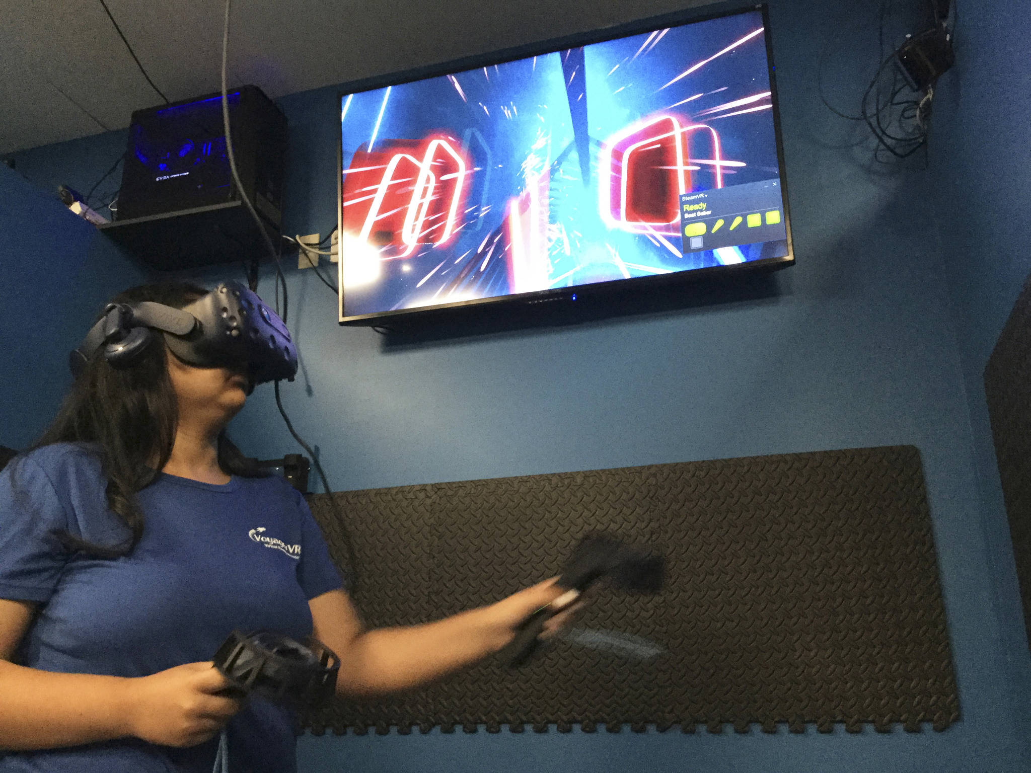 Leah Holley plays the virtual reality game, Beat Saber, using lightsabers to slash cube-shaped musical beats synchronized to music as they race towards her.