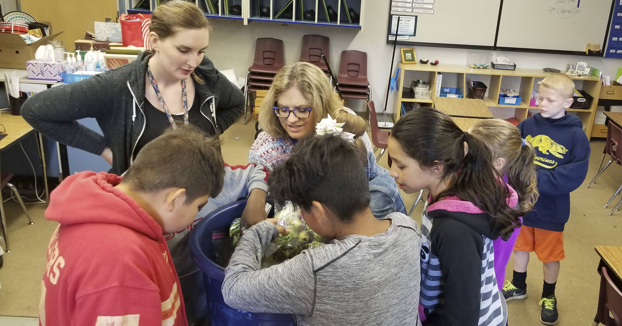 Eagle Creek Elementary summer camp students select vegetables that were grown at the school this past year. A garden was grown at the school to teach students about the growing process.