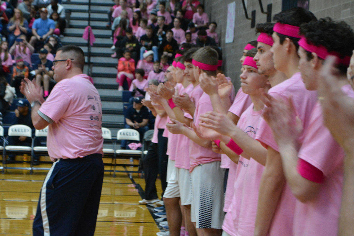 Arlington High School boys basketball coach Nick Brown applauds during the opening ceremony of last year’s Coaches vs. Cancer game. (File photo)