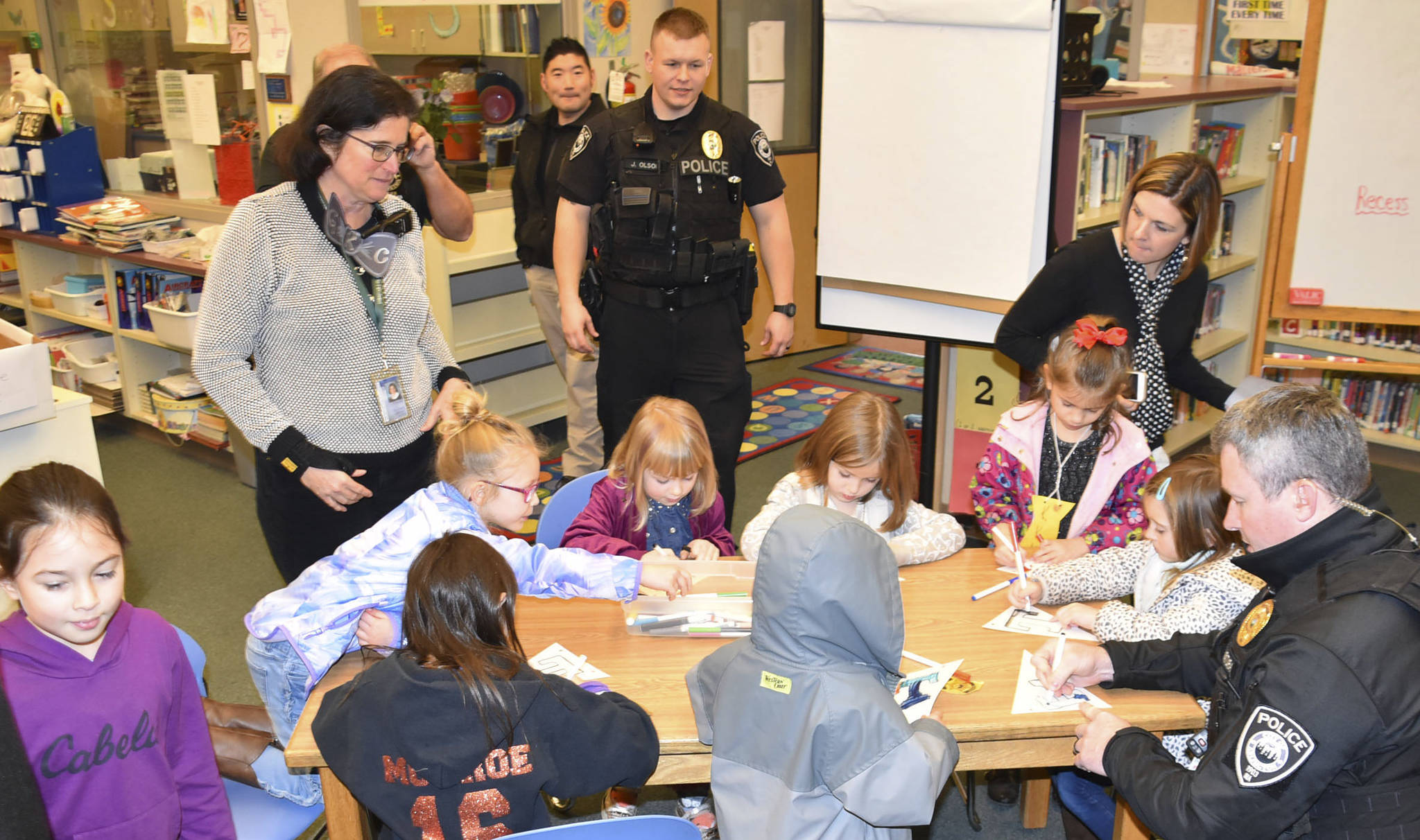 Arlington police officers color pictures with Eagle Creek Elementary students during the Great Kindness Challenge Jan. 29. The nationwide event is designed to spread kindness in the community.
