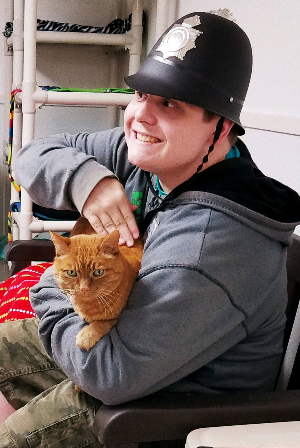 Brian Abelson pets his favorite cat, George, while volunteering and picking up job skills at Purrfect Pals in Arlington.