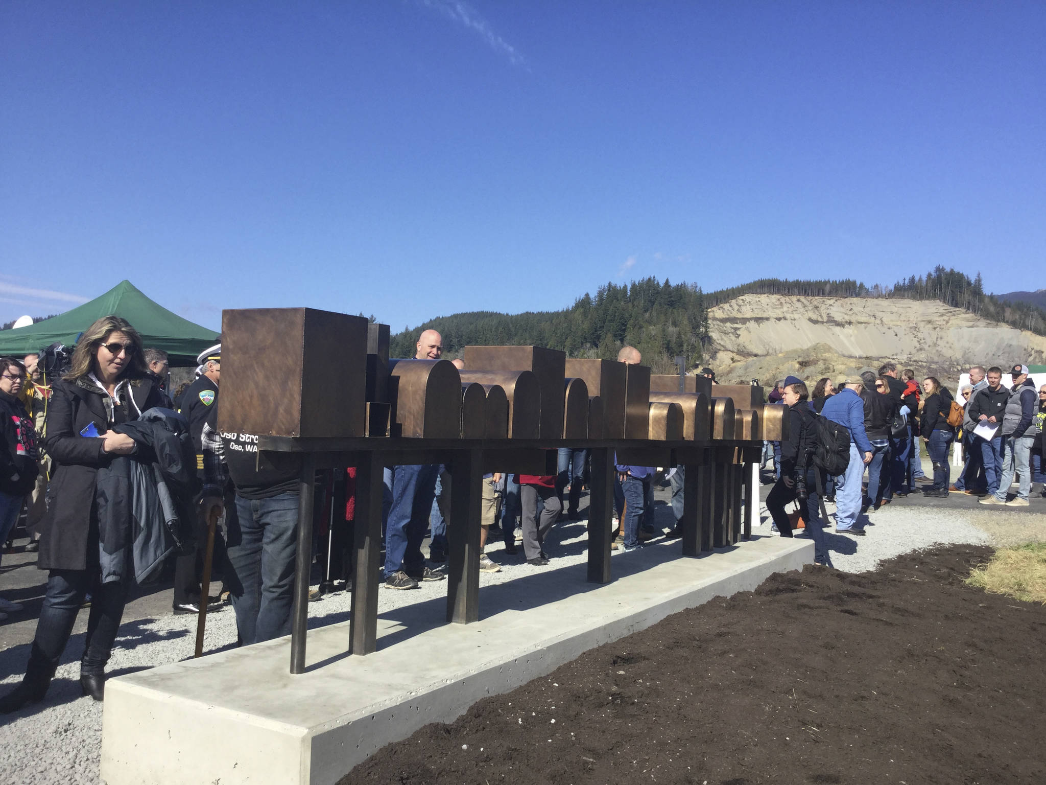 A bronze sculpture titled “It was a Home” depicting a row of mailboxes that stood at the entrance to Steelhead Haven was unveiled during a memorial remembrance ceremony marking five years since the Oso landslide.                                ‘Always in our hearts. Never forgotten.’