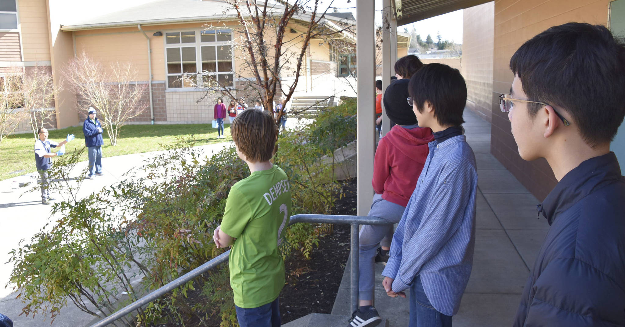 Two Japanese students observe Haller Science teachers Roel Ubungen and Scott Rice conduct a dry ice experiment. Twenty-two Japanese students visited Arlington to experience how students learn in America.