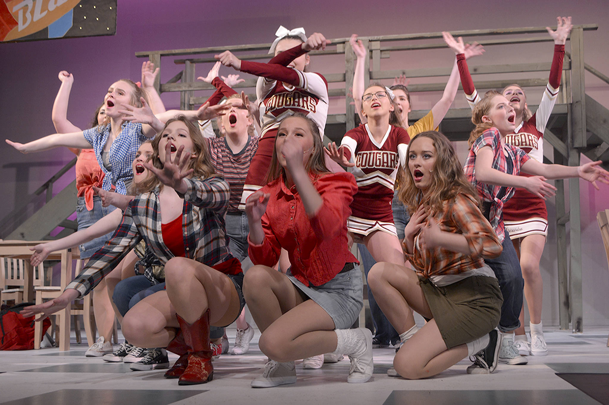 Female cast members, led by Aerial (Audrey Stich) end one of their songs in a big way.