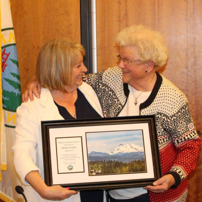 Mayor Barb Tolbert presents Shirley Prouty with volunteer of the month award.