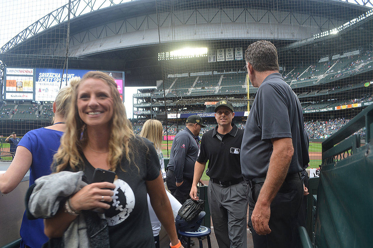 Steve Powell/Staff Photos                                 Danna and Tripp Gibson of Marysville walk off T-Mobile field prior to a recent game that he umpired.