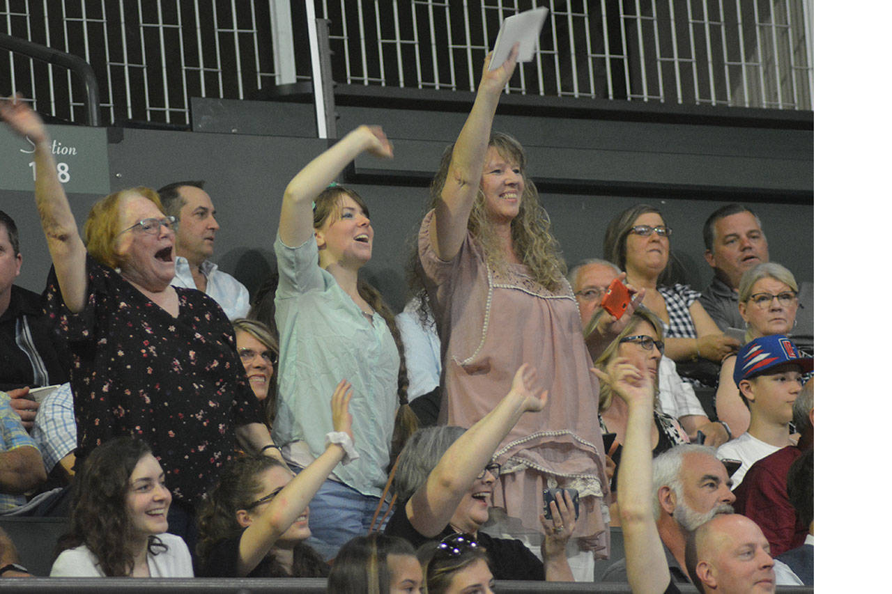 Steve Powell/Staff Photos                                 Families in the crowd at the MG graduation often stood and yelled as their graduates entererd the arena.