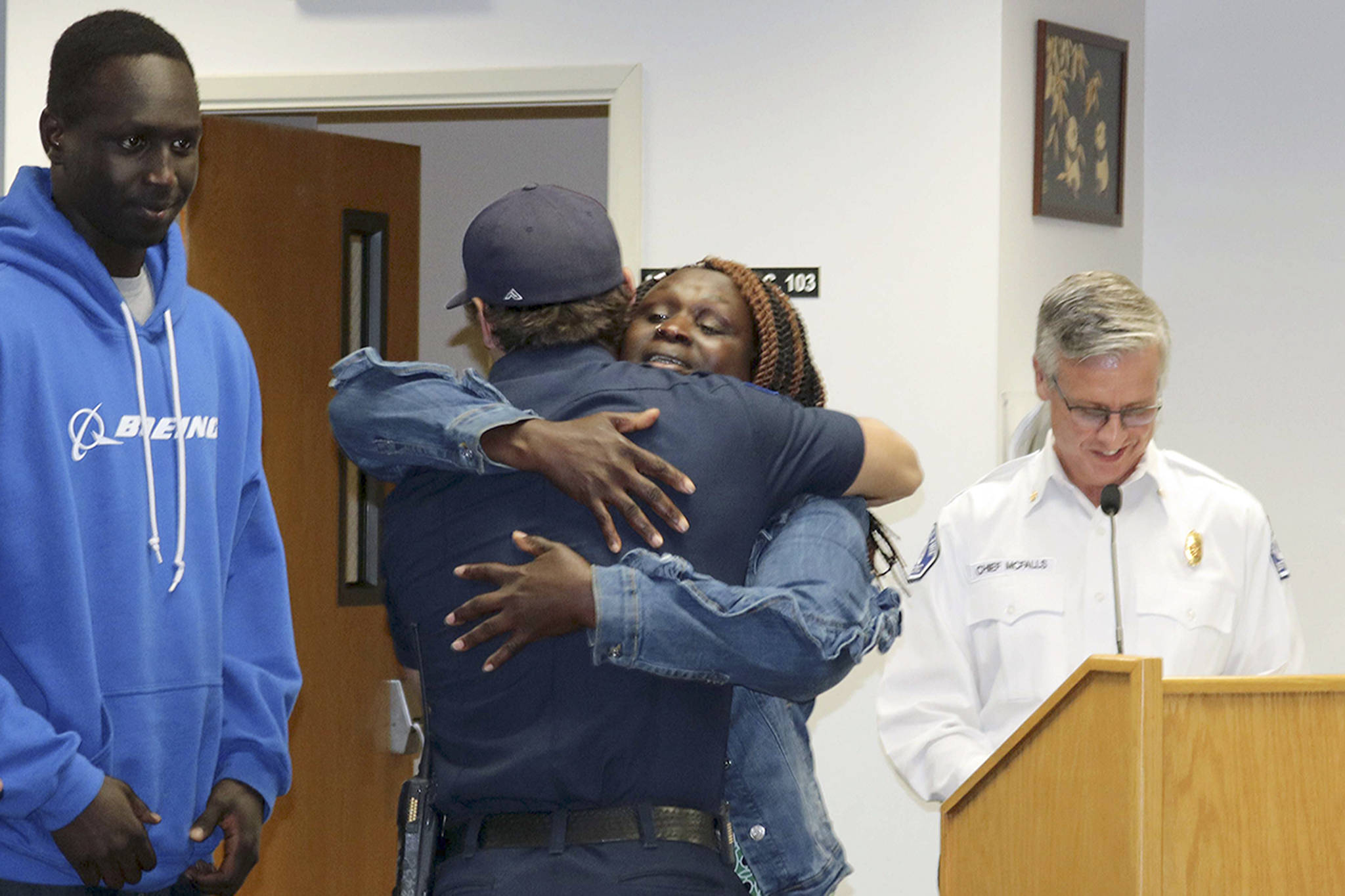 Courtesy Photo                                 Palek hugs Day as William and McFalls watch.