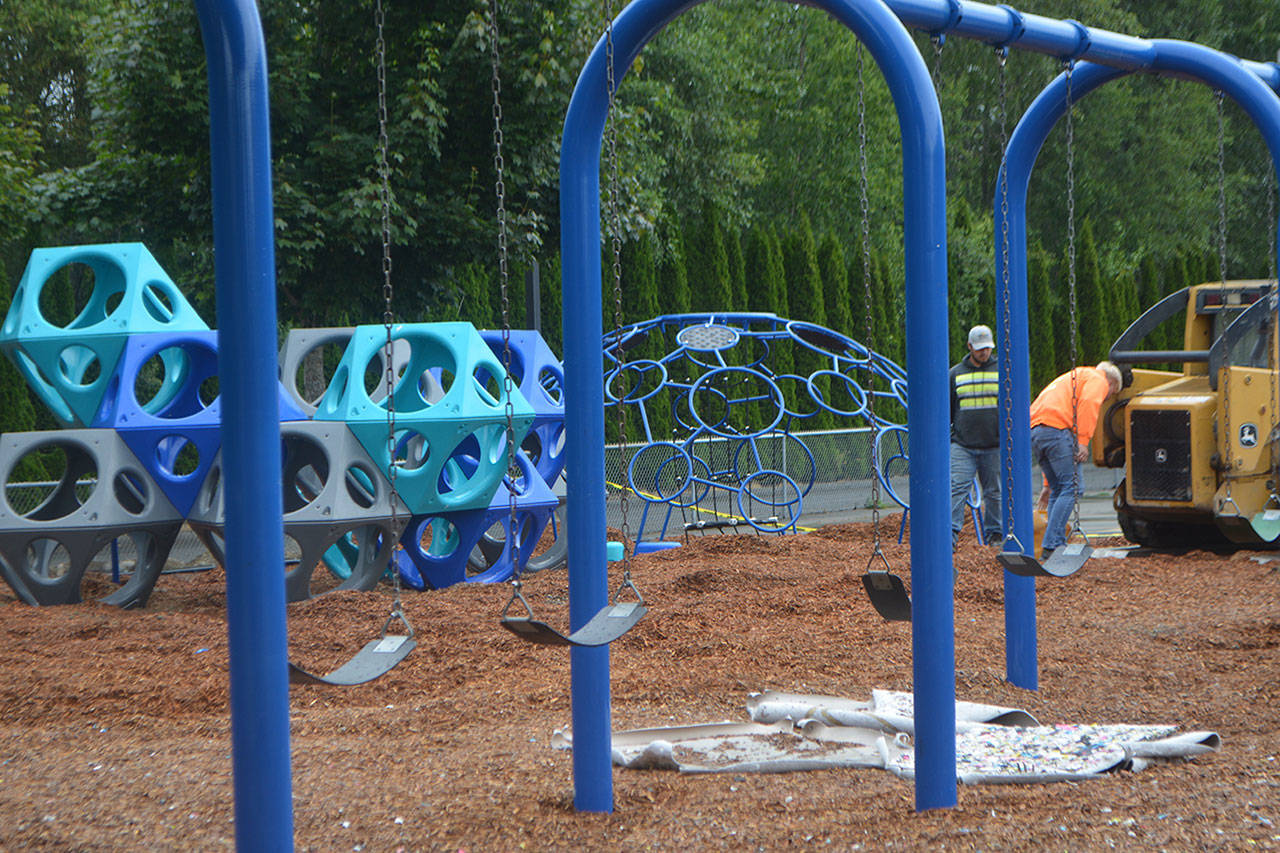 Workers put together the new playground at Allen Creek Elementary School in Marysville. (Steve Powell/Staff Photos)