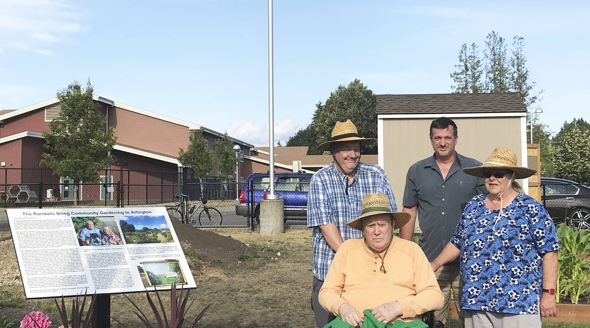 Chuck and Bea Randall were honored for bringing community gardens to Arlington during a ceremony at the new Third Street Garden at 505 E. Third Street. Pictured here with sons Aaron, left, and Bill.